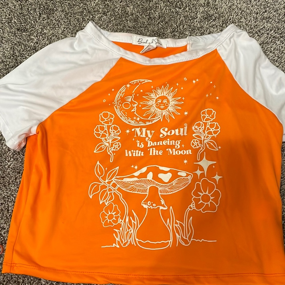 Medium orange and white top that says “my soul is dancing with the moon”